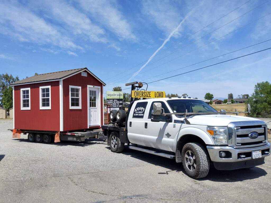 Truck delivering red ranch shed