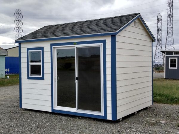 White Ranch Shed with blue trims and patio door