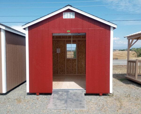 Red storage shed with roll-up door open