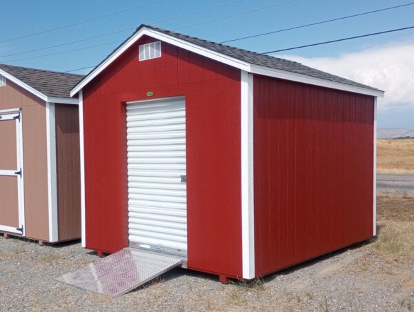 Red storage shed with white roll-up door